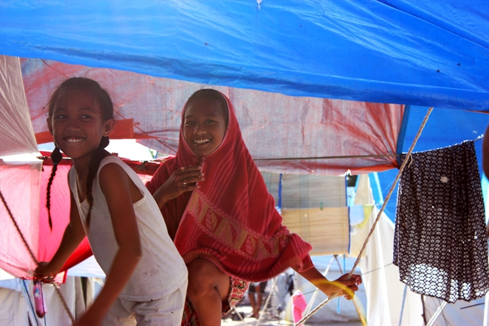 Out of 2,606 individuals temporary residing in the evacuation center, Friends May Beth and Daniella (Left-Right) smiled as they saw me take their photo while they were roaming around the ‘village’, passing through ropes, hanged clothes, and large sheets of tarpaulin, during their spare time to find and play with some friends.