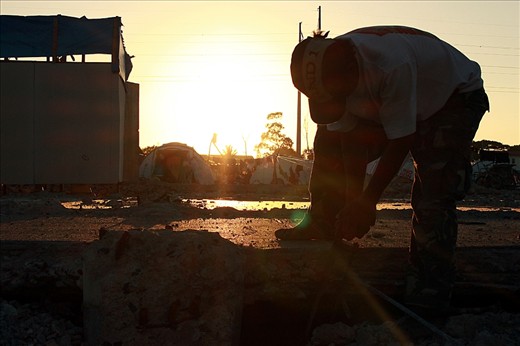 Metal Miners. Most men inside the evacuation center took advantage of their temporary stay to gather metals to gain additional income. Under the heat of the afternoon sun, one resident of the ‘village’ works hard by gathering metals inside the vicinity of the evacuation center and trading those to earn extra money for his family. The metals being dug or removed were leftovers from the bottling company building formerly erected on that area.