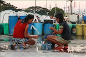 Because water is barely accessible the community’s small improvised bathroom, these ladies took a bath on where water is most likely accessible—beside pails of water. Those stockpiles of large pails of water are just a part of 8 tanks of water delivered by the firemen that day.: by shelterbox, Views[946]