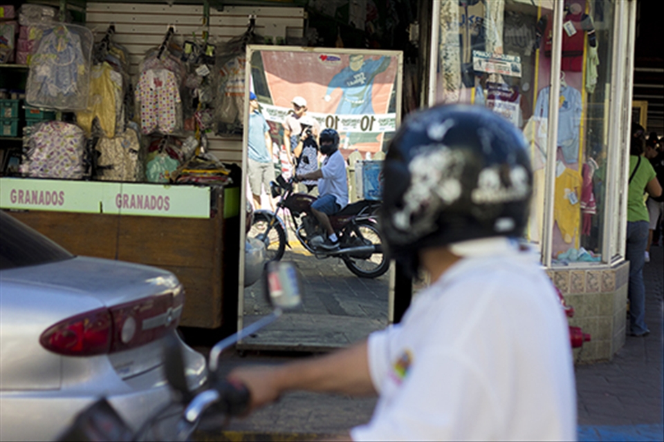 Is it consciousness, curiosity, or both? The man with the bike turns to see what I am photographing, soon to find that it is he.