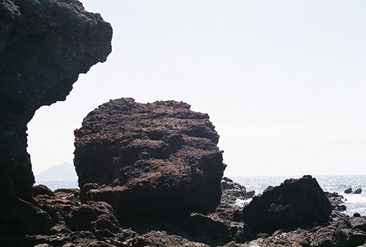 The Oyster Fisher, cleaning his catch. Many men seek to the pacific ocean nearby for food to eat and to sell, in an effort to support their families; it's not much, but it gets them by.