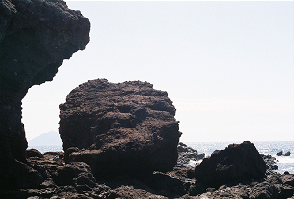 The Oyster Fisher, cleaning his catch. Many men seek to the pacific ocean nearby for food to eat and to sell, in an effort to support their families; it's not much, but it gets them by.
