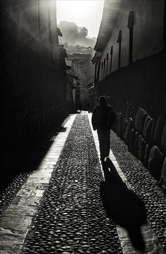 Early one morning at the crack of dawn, after attempting to photograph a Cusco sunrise, I spotted this man walking up the Calle Triunfo, a famous Incan stone-walled alley.  It was in this moment that I began to see how the Andean people navigate (literally and figuratively) the ancient and modern aspects of their city.