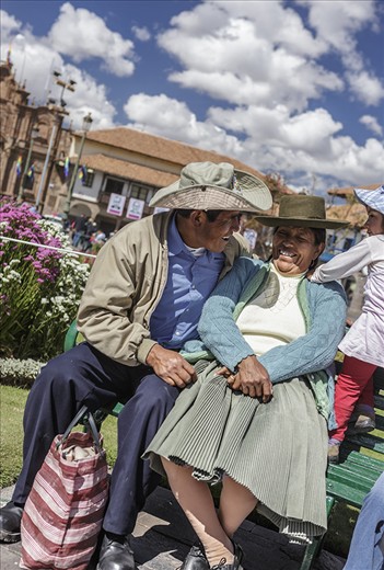 A couple enjoy the day at the Plaza de Armas with their daughter during Cusco Carnival or Cusco Week, when there are daily processions in the Plaza de Armas, the central plaza in historic Cusco.  