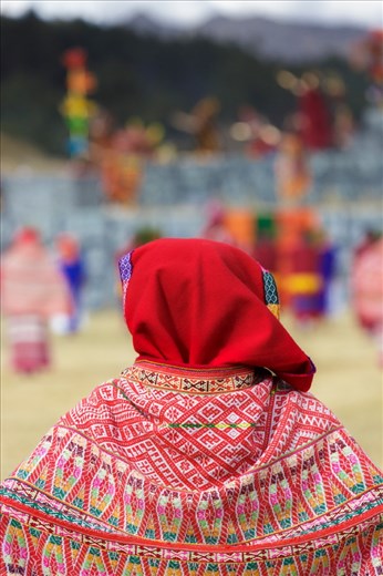 An actress dressed in the traditional garb of one of the realms of Tawantinsuyu (the Incan Empire) watches the High Priest perform a final, re-enacted ritual sacrifice of a white alpaca (basically a giant puppet with fake guts inside) and read the omens contained within its 