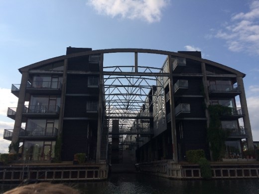 From the canal boat tour - one of the previously industrial/shipping areas turned into residential housing without completely destroying the former building. Notice the arching steel at the roof line.
