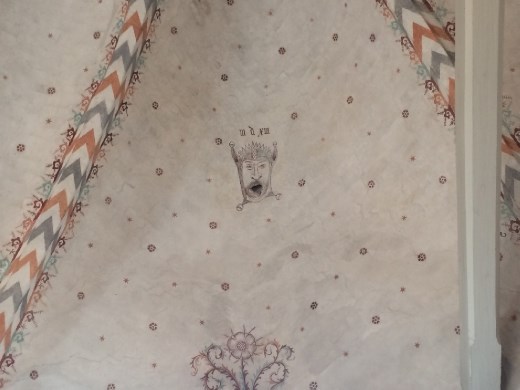 Original fresco. Apparently when an artist didn't like his pay he would add a fool's head somewhere in his work. You can see here how the old bell pull has worn the fool's mouth wider over the centuries.