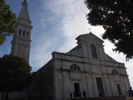 The Church with the bell tower rising above on the left. 