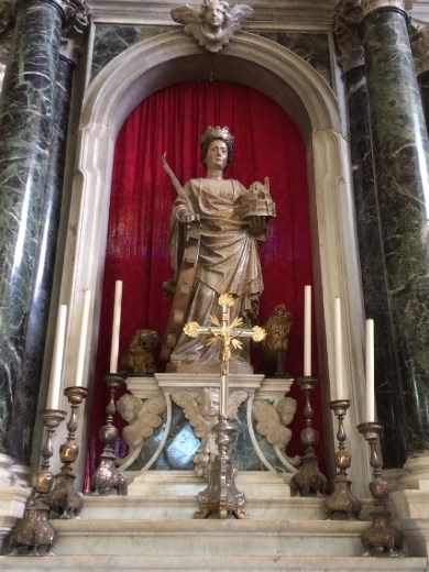 Statue of St. Euphemia leaning on the wheel with which she was killed. At least this figure has risen above her torture.