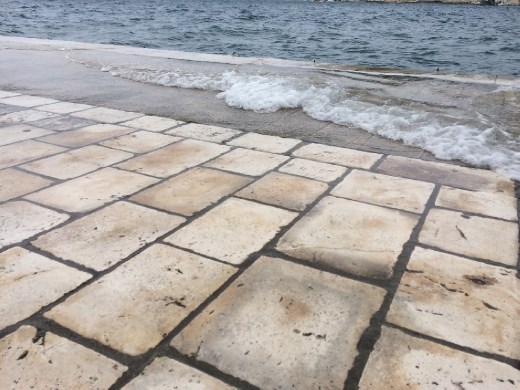 With rather rough water the ocean occasionally covered the entire harbor walk.