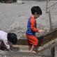 Two children play in the brook of shrine,unaware of holiness & curative water by: shrine Views[285]