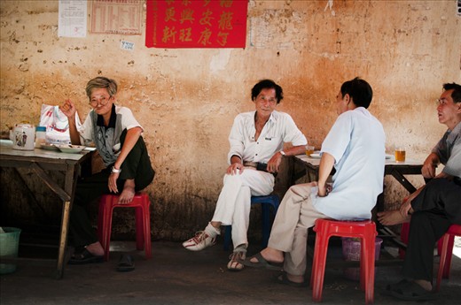 There are thousands of small restaurants in the tiny side streets in the capital Phnom Penh. Everywhere people are enjoying a hot soup for breakfast and drinking tea. These men were having an ardent conversation. They saw me taking pictures but they didn’t care. Then they stopped talking and looked into the camera. There was a short break of their conversation, kind of peace between them. 
