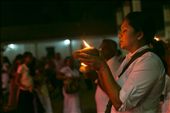 Kataragama, one of the most sacred sites in Sri Lanka. One of many devotees requests a boon from the god, holding aloft a coconut on which a camphor fire burns.
She will later smash the coconut on a rock, and hope it splits auspiciously into two equal halves.: by sifaan, Views[1309]