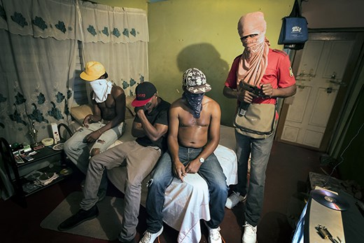 Leaders of the Rema Crew gang pose in their home for a photo