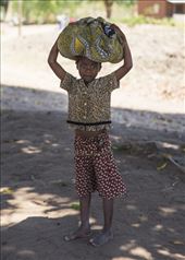 Passed on from ancient traditions, women including this young girl still carry loads on their heads where there is no less expensive, or more efficient, way of transporting things. Sometimes, women and girls carry up to 70% of their body weight on their heads. Men and boys are not seen doing this generally.: by simbolism, Views[849]