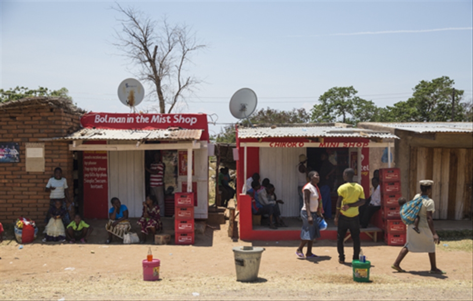 I met Happy in Chitimba village in the northern part of Lake Malawi. He was born in Lilongwe but moved to Chitimba and owns this corner shop where he sells cold drinks and snacks to the locals. As the village is close to the Tanzanian/Kenyan border, he also services people trading over the border. Not much goes on in the village, so you can see locals hanging around the shop and kids watch soccer on the TV in Happy's shop.