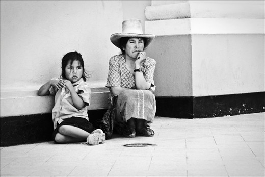 Sunday Church in Trujillo. A girl and her mom asking for money at the entrance.
