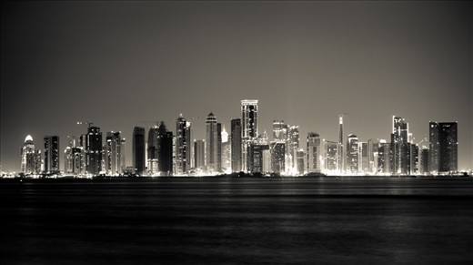 A modern city perched on the edge of sand and ocean towers into the sky where only decades before, pearls were traded for food and clothes