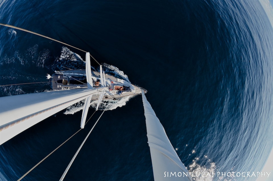 A World of our Own. We left Newport, Rhode Island on a 64ft Sailboat heading to the British Virgin Islands. Day 1 began with stormy seas, and after a rough night we were greeted with glassy calm conditions. The flat seas allowed me to take this photo. I climbed 85 feet up to the top of the mast with my camera firmly strapped to my back. I selected this photo because it captures one of the feelings onboard the boat; that when you are surrounded by endless horizons and there is no land in sight, it literally feels like your in your own little world. 