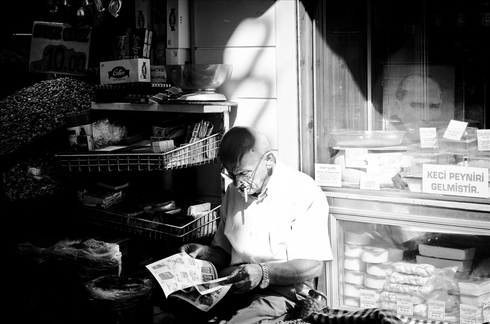 This gentleman selling tobacco was taking a well deserved smoke break. 