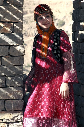 a young kurdish girl in costume.