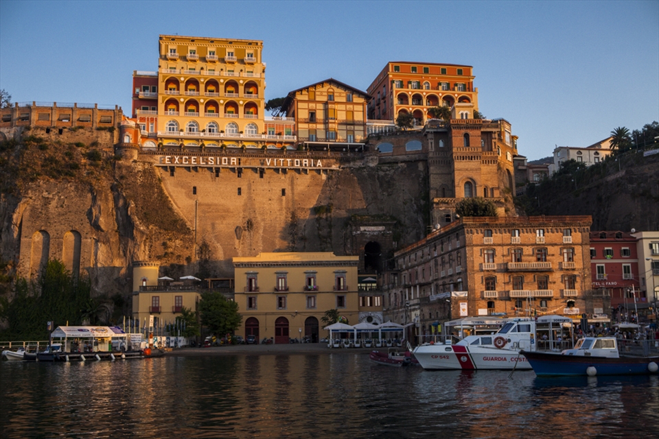 Cliffs in Sorrento's harbor seen from the Capri-Sorrento boat at sunset.