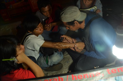 a man drawing the temporary tatoo