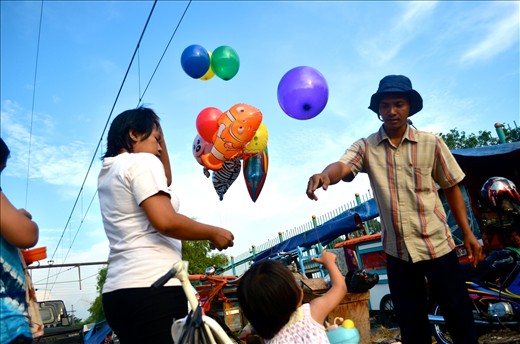 a mother bought a ballon for her child at rail market at sunter north jakarta