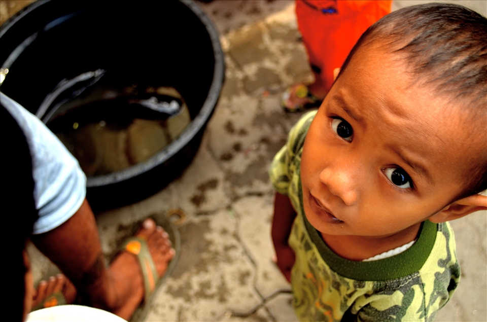 a children playing with catfish,happiness is a simple thing for them.