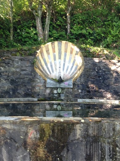 Camino sea shell at a water stop