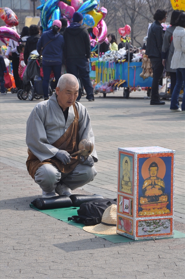 Going Solo on a Sunday.  In urban areas, weekdays are for Seoulites to dance to the tune of long hours in offices and businesses where eleven o’clock in the evening still manifests rush hour commute.  Weekends are reserved for other obligations like how most spent this Sunday with family.  This grandpa spent his with religion. (Seoul, South Korea)
