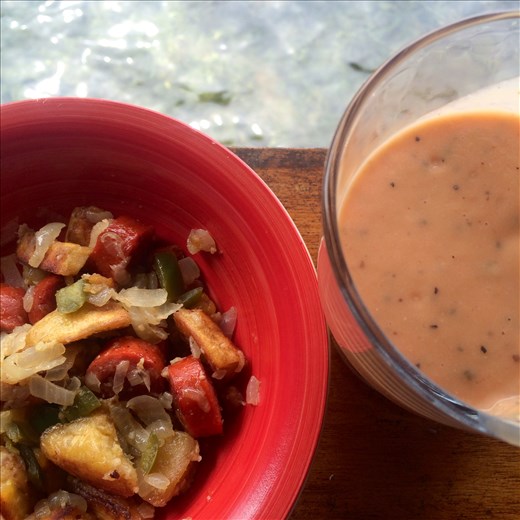 Breakfast hash and a smoothie made in a kitchen over the water.