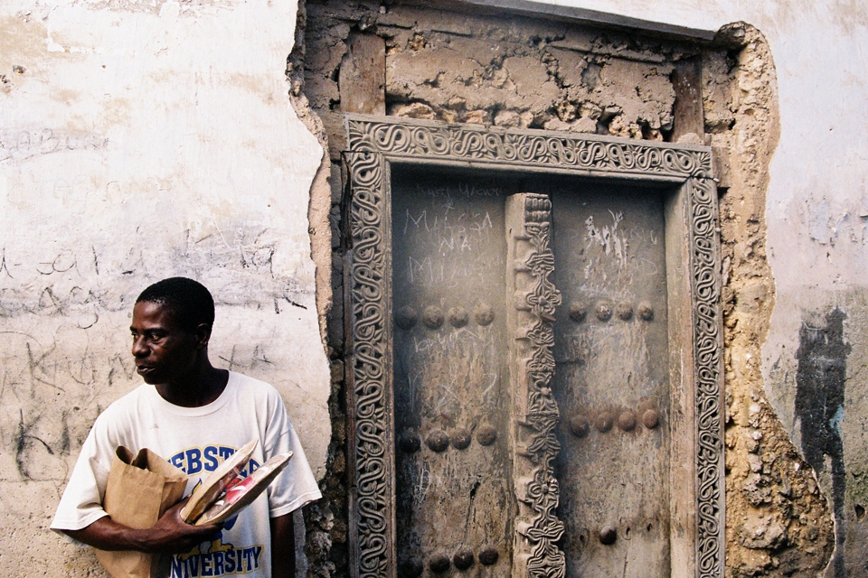 man standing outside doorway