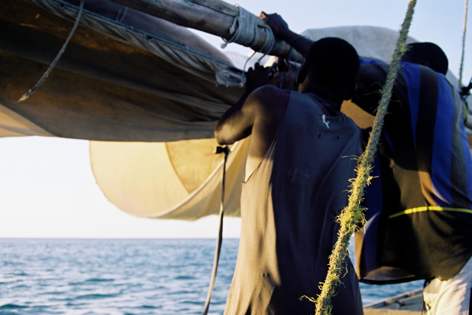 fishermen loosening their sail