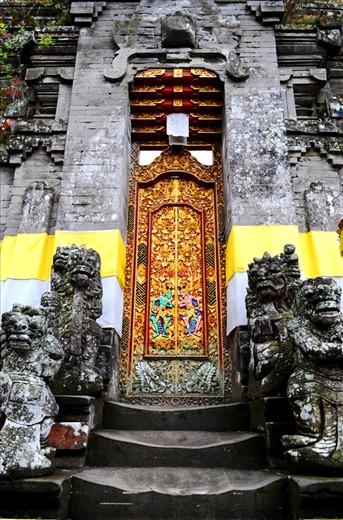 pura building is a place for prayer for the Balinese Hindu religion. Temple building has special characteristics that would be comparable with other buildings such as, at the door we could see the beautiful carvings, standing at the front door a few statues that are considered to have magical powers, and there is a yellow and a white cloth covering the wall of the temple. White and yellow cloth is a symbol of holiness for the Balinese Hindu religion.