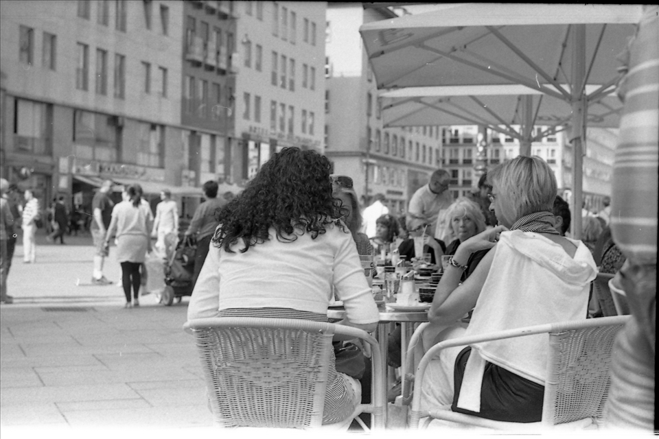 Central street, central caffe. Lot's of people having their time and their fun.