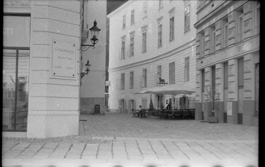 A small street just in the centre. Some empty caffe near the crowded one.
