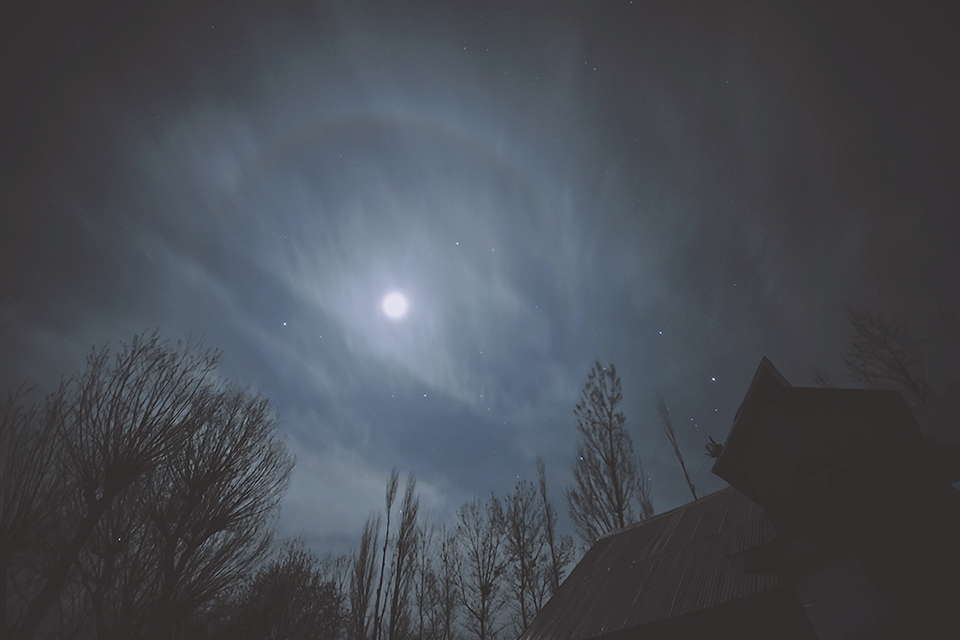 A rooftop of a farmer's house in Kalishepora at Srinagar, Kashmir gave this magnanimous view of the moon with an encircling halo. The winds were high and very chilly, but the imagery above surpassed the discomfort of being out there.