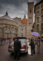 About 30 seconds after walking past the Florence Duomo, the rain started.  I ran back and was photographing the explosion of colours (umbrellas) reflected in the wet surface when this Bride turned up. It amazes me that while tourists  flock to Italy's beautiful architecture, Italians  go about their business as if these wonders are an everyday thing. To them, of course, they are.: by smarlin, Views[675]