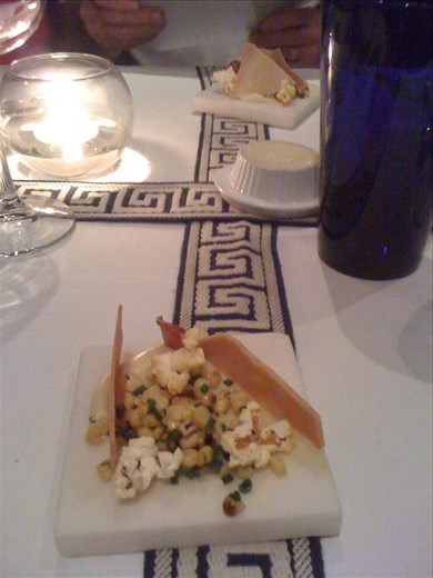 First course grilled corn Parmesan crisps, salami slice, popped corn elegant.