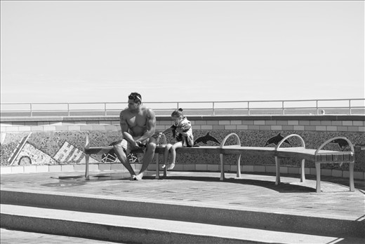 The body language of the subjects in this photograph screams. The feeling is one of encompassing loneliness because the feelings that the subjects are experiencing are solitary. They aren't interacting with each other, but one can easily make up any number of scenarios that went on between these two, perhaps just 5 minutes before this photograph was taken.