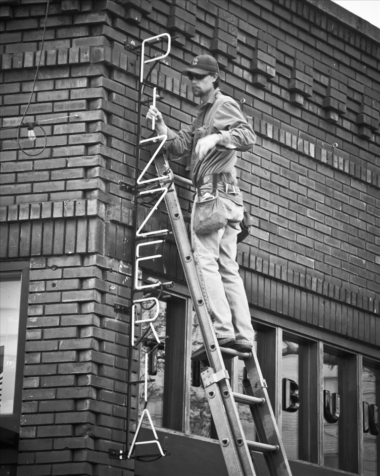 Putting up the sign for the new bussiness that was in town. 