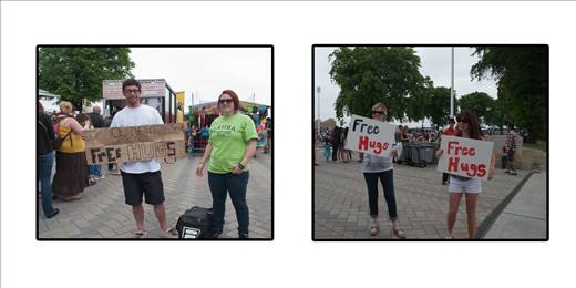 Givng out free hugs in a city. They both were competing to see who could win.