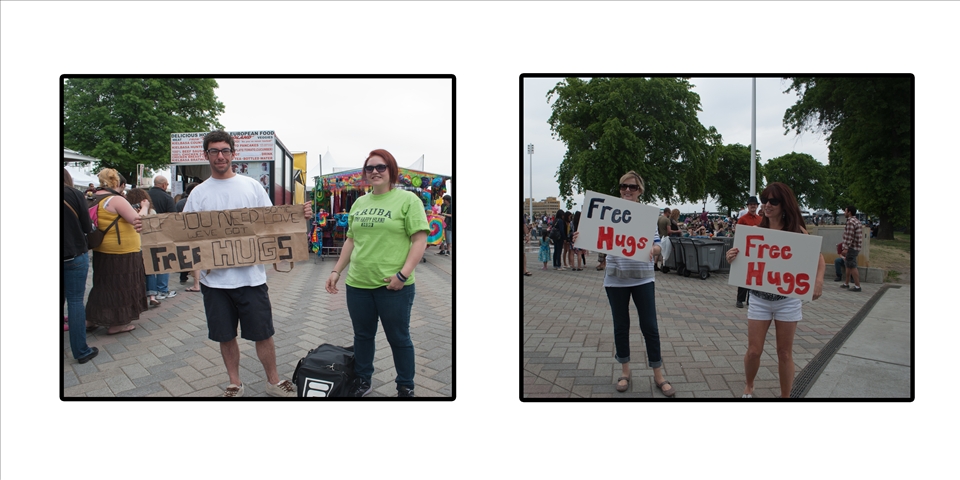 Givng out free hugs in a city. They both were competing to see who could win.
