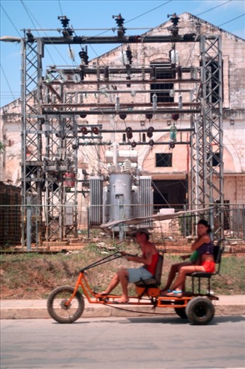 A power grid as a backdrop to a common form of local transport- the small-engined tricycle buggy.