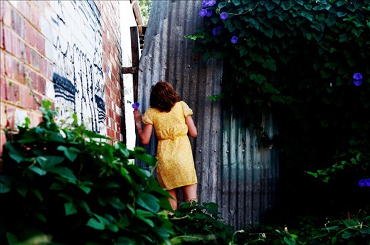 At the back of the walls debris, there is a garden no one took care of for a while. It looks wild to be in such a timeless place  in the middle of the city. She seats there, staring at emptiness and asks me ; 