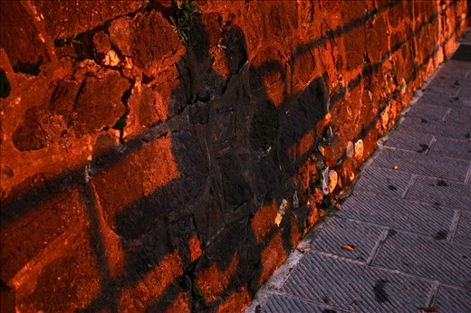An elderly couple sit arm in arm to watch the sun set. Levanto, Italy