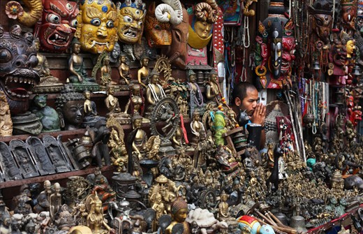 A merchant crouches amongst his wares at Swayambhunath (a.k.a. The Monkey Temple), Kathmandu's most popular tourist attraction. 