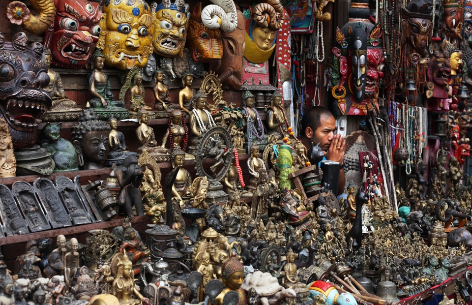 A merchant crouches amongst his wares at Swayambhunath (a.k.a. The Monkey Temple), Kathmandu's most popular tourist attraction. 