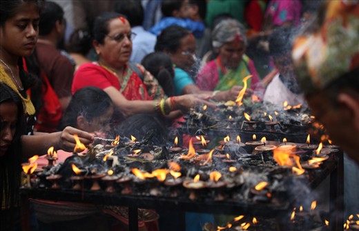 Women light candles during Janai Purnima celebrations, a festival in which women pray for their brothers' and husbands' well-being.